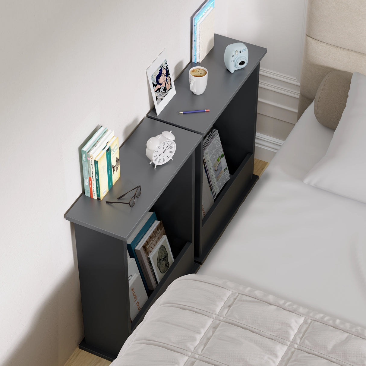 Black nightstand with various items next to a bed in a bedroom setting