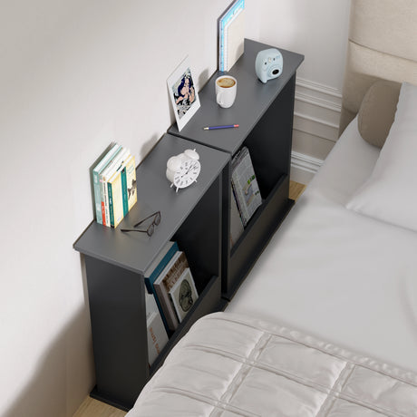 Black nightstand with various items next to a bed in a bedroom setting
