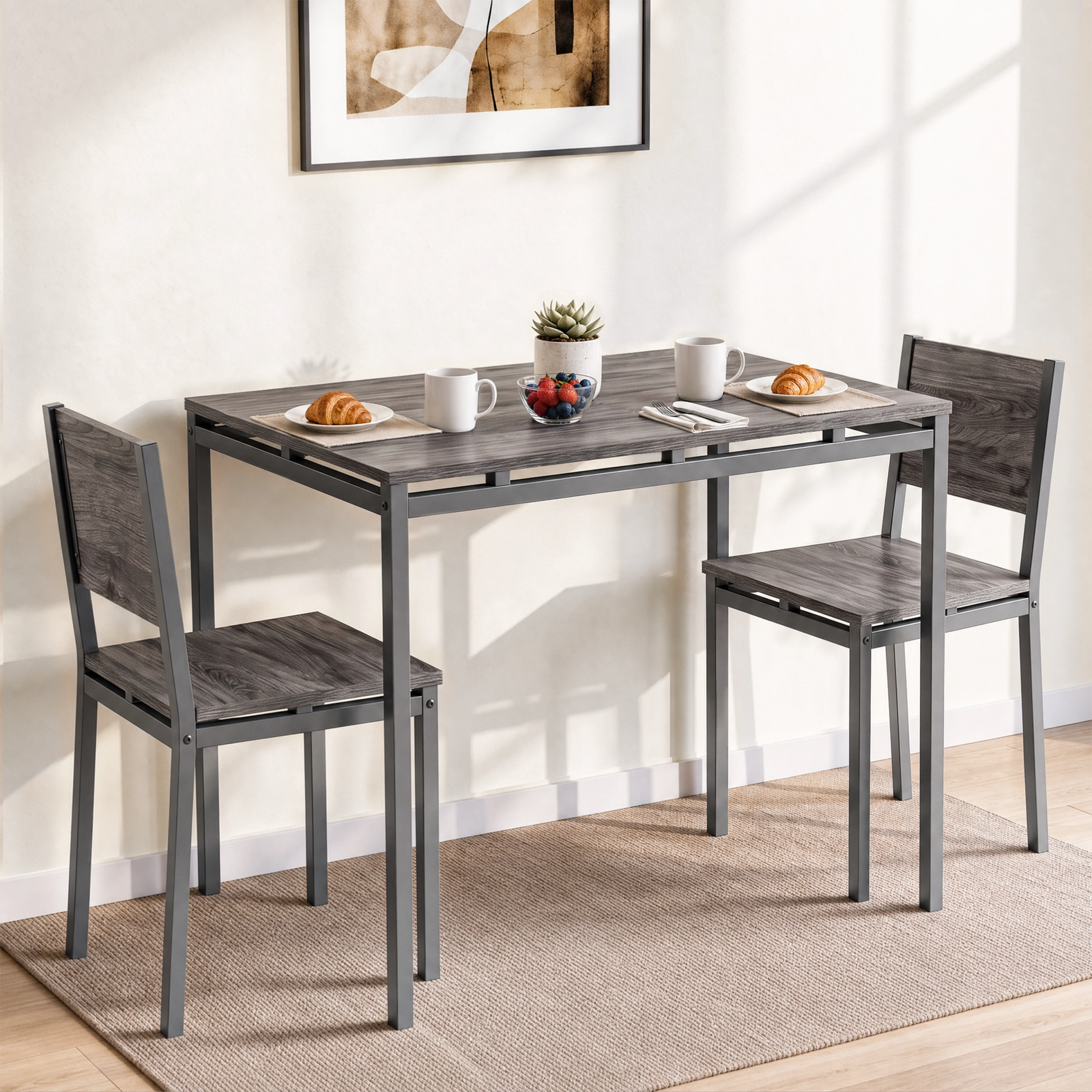 [Grey] Breakfast table and chairs set of 2 styled with croissants, mugs, berries and a plant in a sunlit breakfast nook.