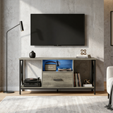[Grey] Calvera grey TV stand against concrete wall with Marshall speaker, vinyl record player and floor lamp left