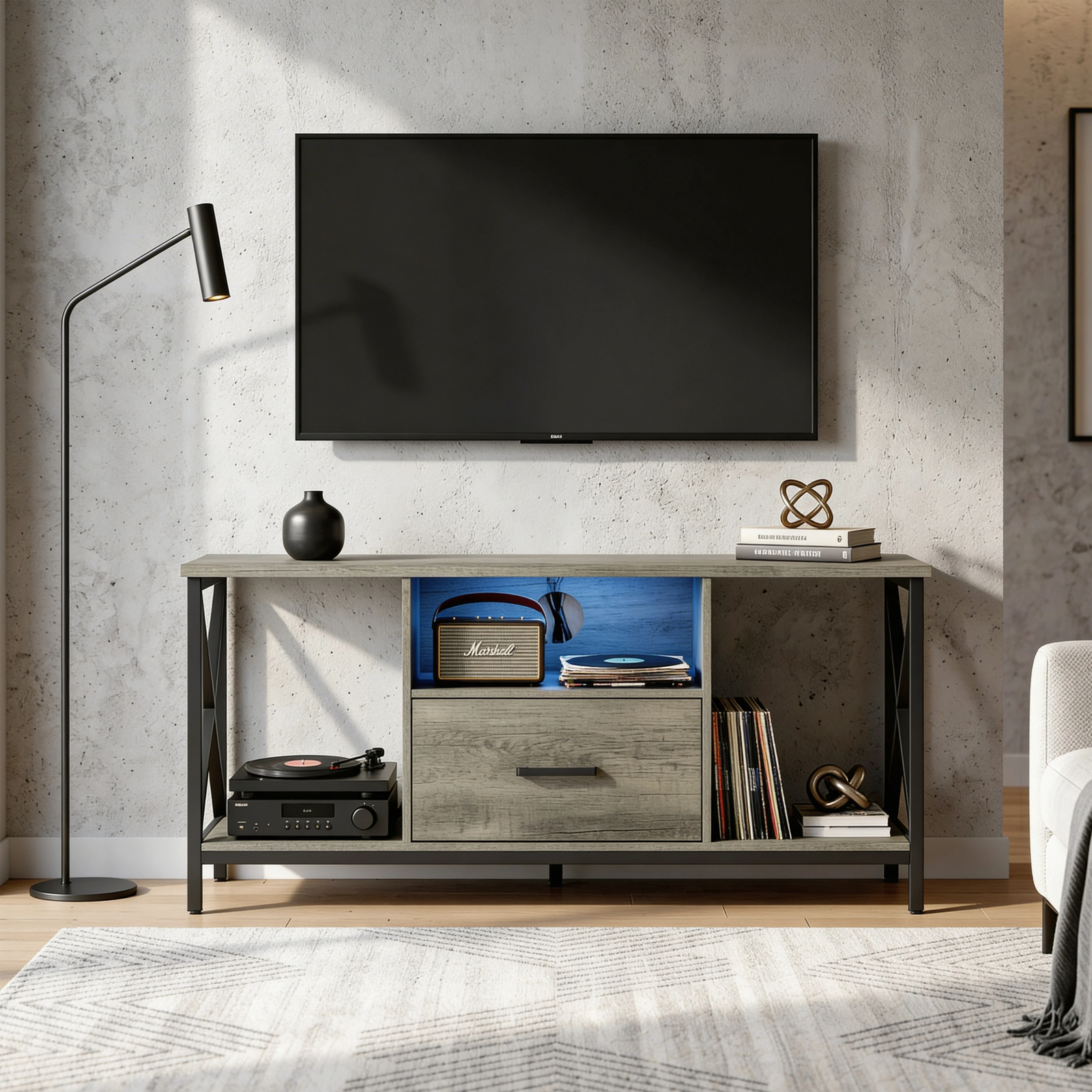 [Grey] Calvera grey TV stand against concrete wall with Marshall speaker, vinyl record player and floor lamp left