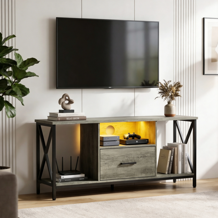 [Grey] Calvera grey TV stand below wall-mounted TV with vertical wall panelling and fiddle-leaf plant on the left