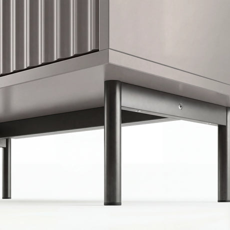 Grey bedroom drawers base detail highlighting raised black metallic legs in modern and stylish design