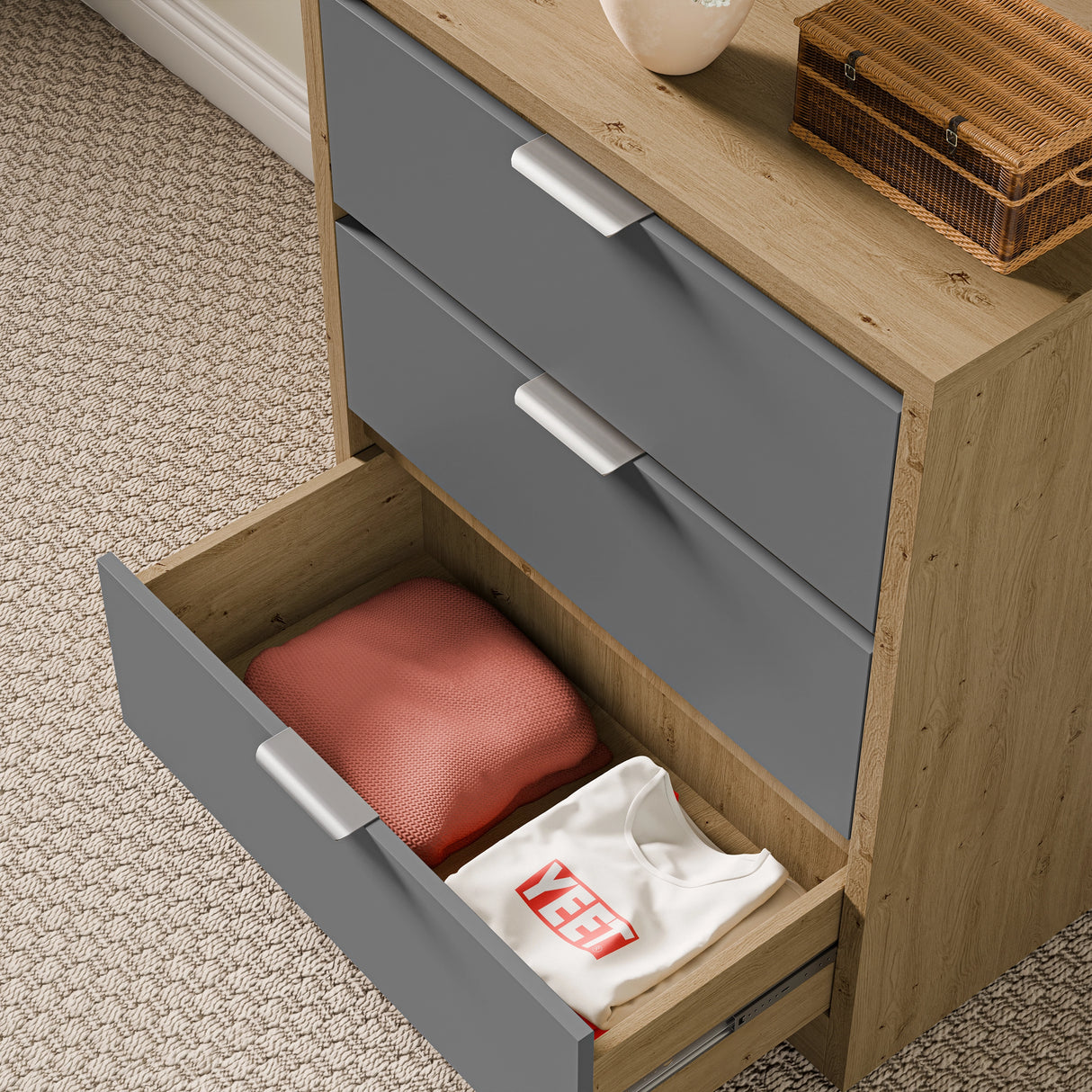 Drawers for bedroom in oak and grey finish, with the bottom drawer open showing neatly folded clothes inside
