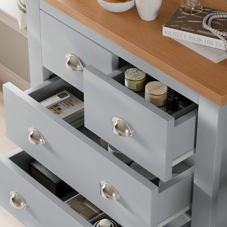 Close-up of grey chest of drawers from Shaker 4 Piece Bedroom Set with open drawers displaying organized storage for personal items.