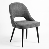 [Grey | Set of 2] Angled view of the comfy modern dining chair with rounded open back, piped seat and four black legs.