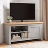 [Grey] TV stand with a light wood top, shown in a styled room setting with a flat-screen TV, a small potted plant, and decorative items on and inside the shelves
