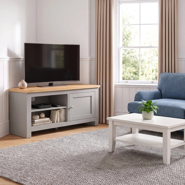 [Grey] A living room scene showing a blue sofa, white coffee table, grey rug, and a grey TV stand with a television, set in a bright room with beige curtains and wood flooring.
