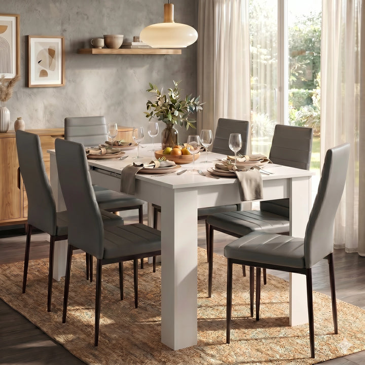 [6 Seater | Grey] Dining Table and Chairs Set with six grey padded chairs around a white table in a bright open-plan dining room with garden view