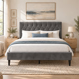 [Double | Grey] Straight front bed view showing a tufted headboard, padded footboard, bedside drawers, lamp, and wall art.