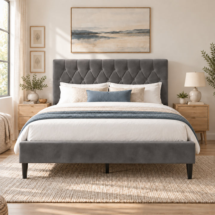 [Double | Grey] Straight front bed view showing a tufted headboard, padded footboard, bedside drawers, lamp, and wall art.