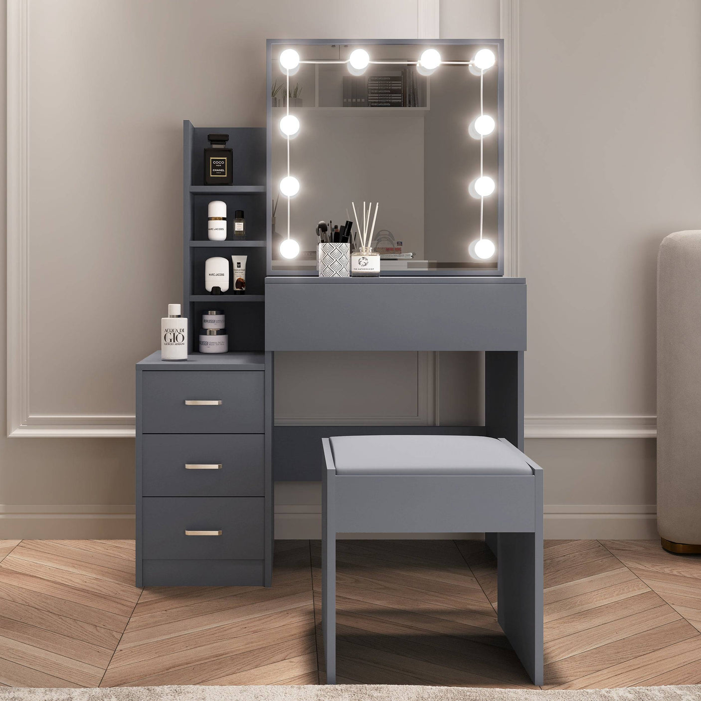 Grey dressing table with mirror, LED lights, drawers, and stool for modern bedroom decor.