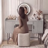 Elegant grey dressing table with a round mirror, featuring a minimalist design and luxurious storage for beauty essentials