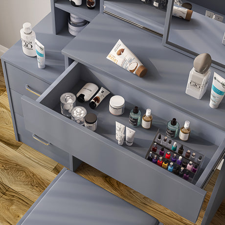 Grey dressing table with matching stool and drawers for stylish and functional storage.