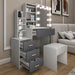 Gray vanity with mirror and lights in a room with a sofa and decor.