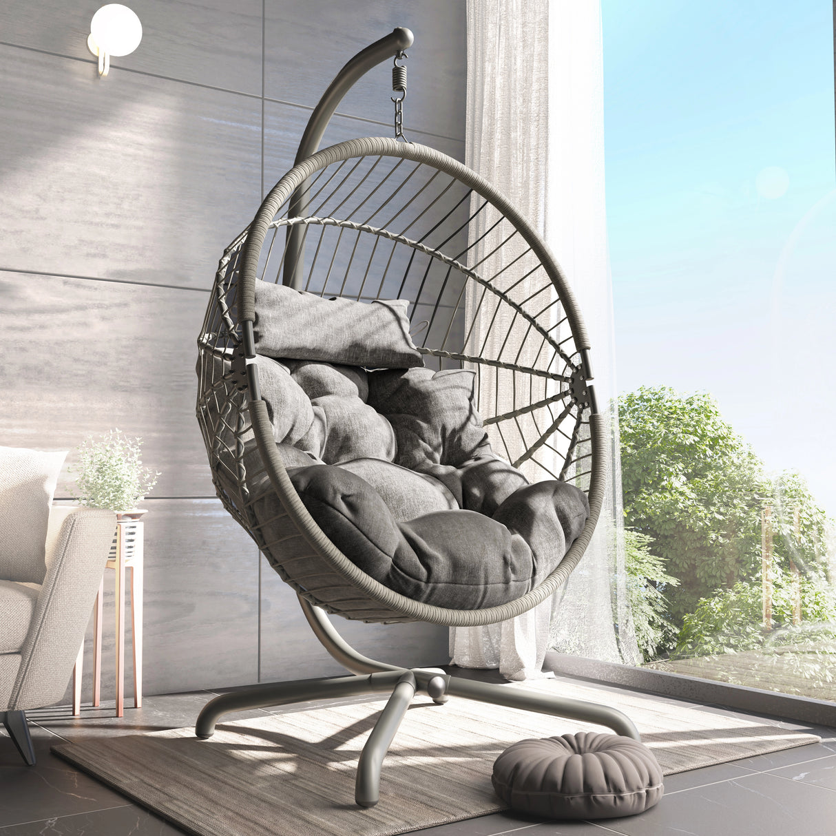 [Grey] Grey rattan egg chair on metal frame beside arched windows, tufted cushions inside shell