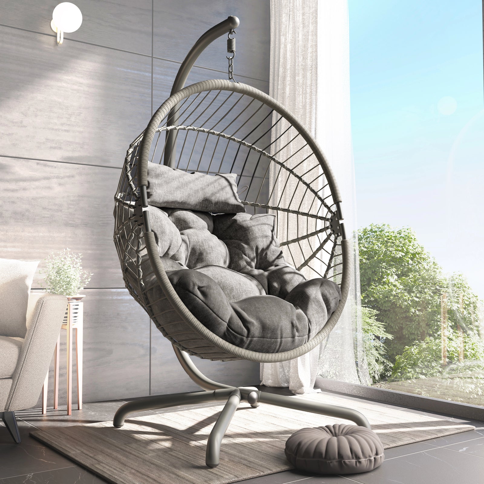 [Grey] Grey rattan egg chair on metal frame beside arched windows, tufted cushions inside shell