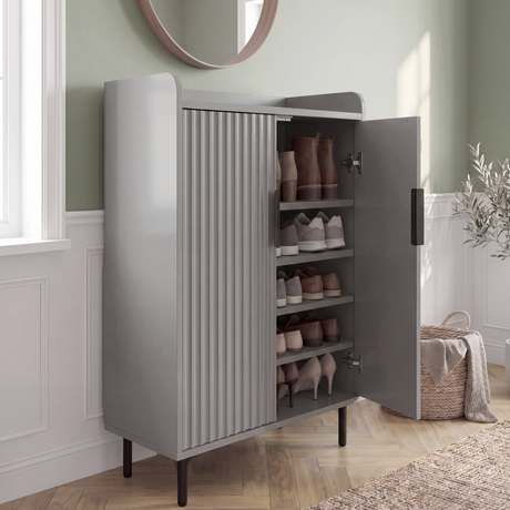 [Grey] Fluted Grey Painted 5 Tier Shoe Storage Cabinet angled open view showing four interior shelves with boots, trainers and heeled shoes in sage green hallway