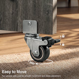 [Grey] Dining table with wheels close-up view showing a 360-degree swivel caster and foot-operated brake.