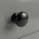 [Grey] Haven chest detail showing a matte black rounded drawer knob set against the smooth light grey painted drawer front