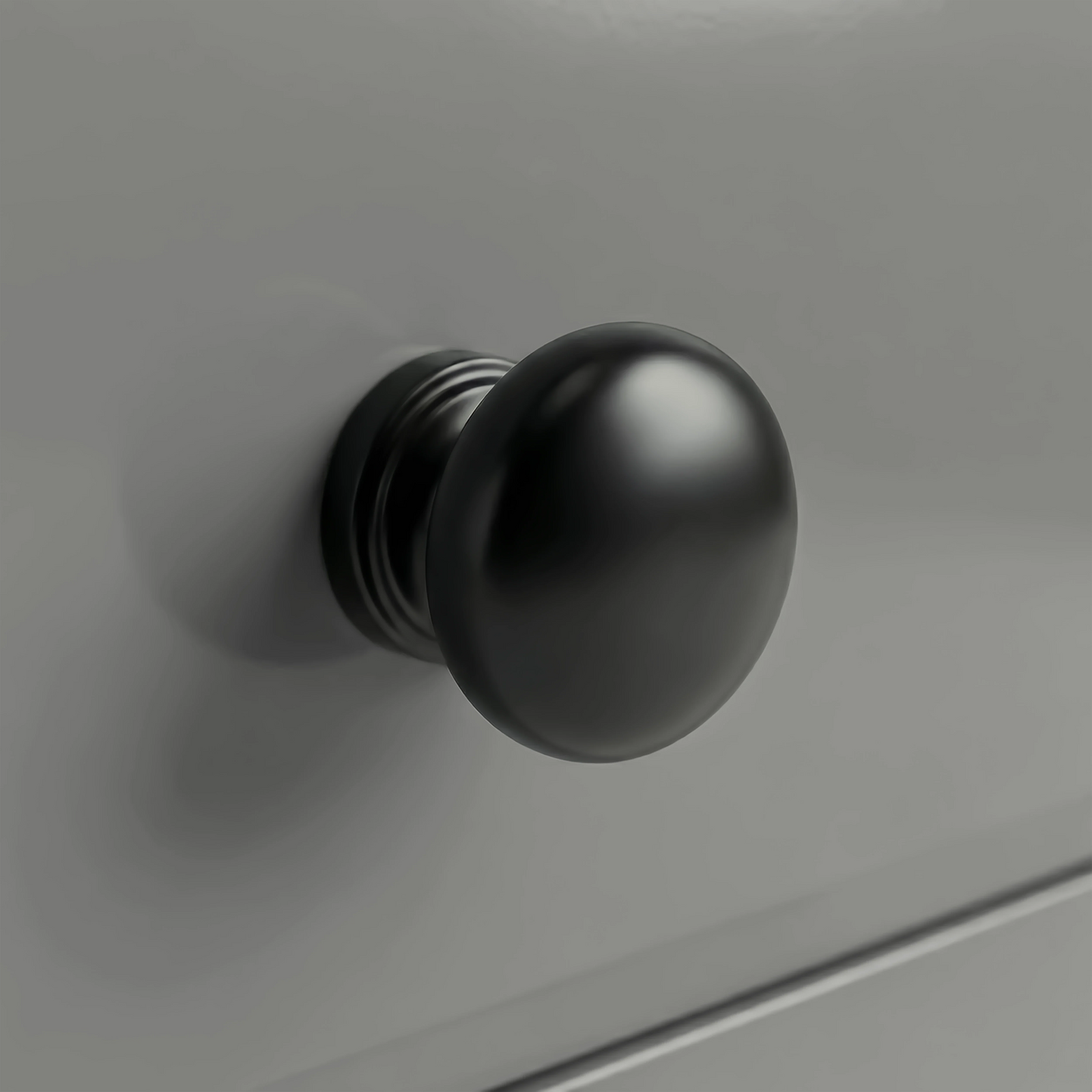 [Grey] Haven chest detail showing a matte black rounded drawer knob set against the smooth light grey painted drawer front