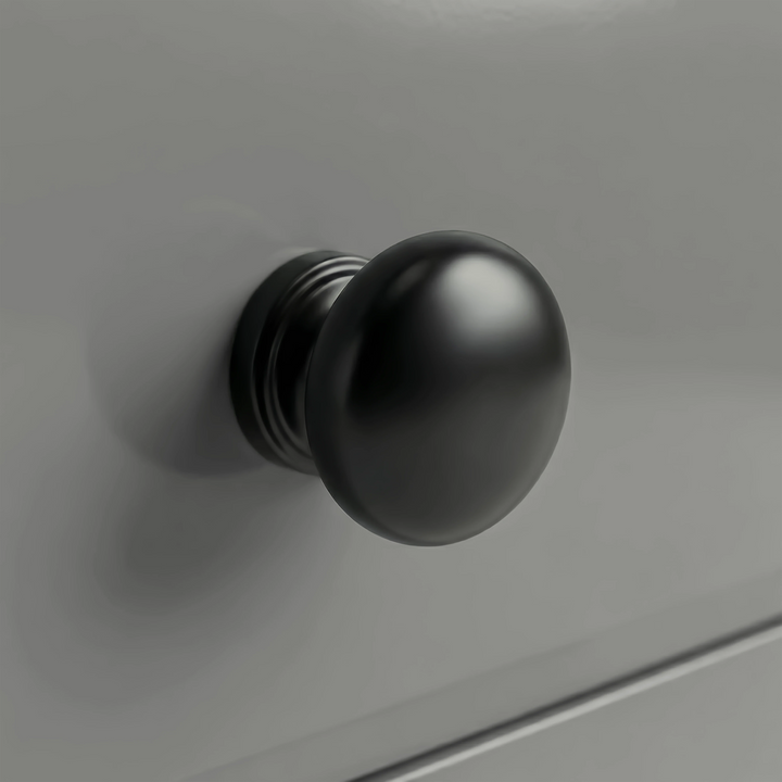 [Grey] Haven chest detail showing a matte black rounded drawer knob set against the smooth light grey painted drawer front