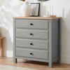 [Grey] Haven 4 drawer chest with oak top and black knobs at a three-quarter angle, styled with dried botanicals and candles