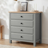 [Grey] Haven 4 drawer chest with oak top and black knobs at a three-quarter angle, styled with dried botanicals and candles