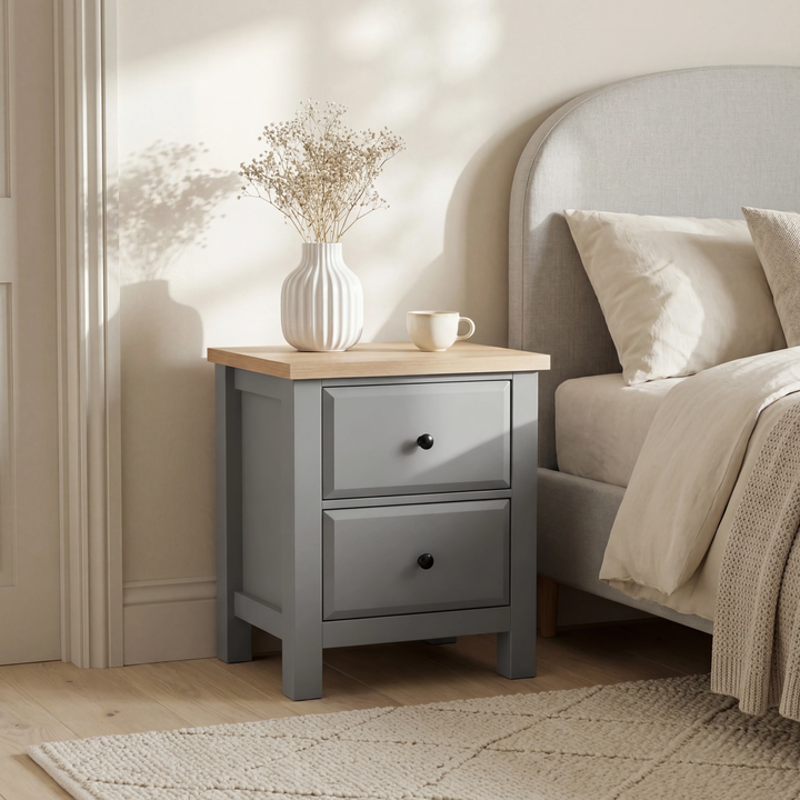 [Grey] Haven bedside table beside an upholstered headboard with dried flowers and mug on natural oak top