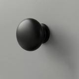 [Grey] Haven close-up of matte black round drawer knob set against light grey painted drawer front