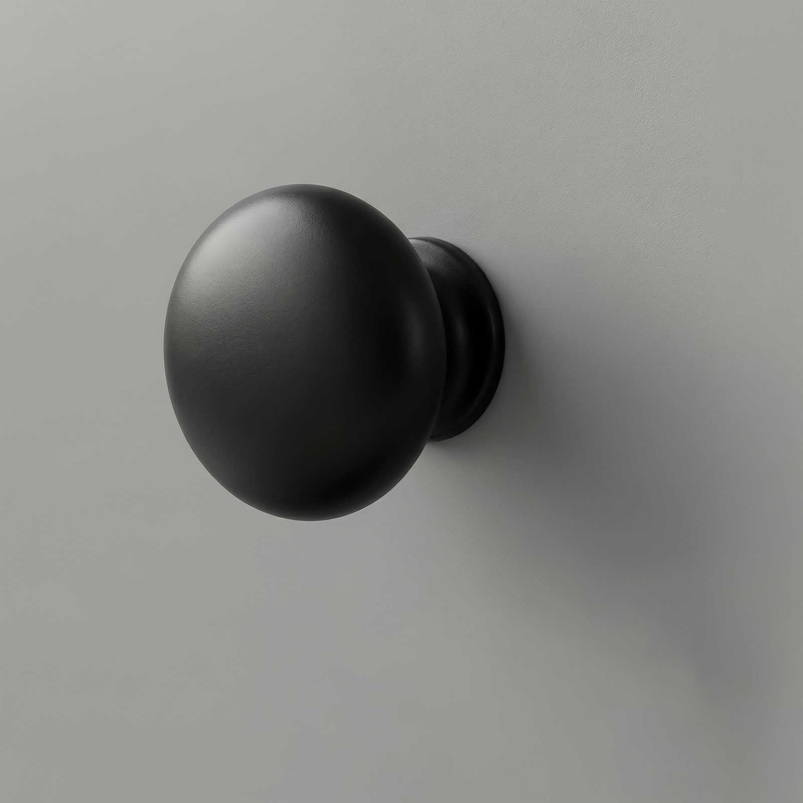 [Grey] Haven close-up of matte black round drawer knob set against light grey painted drawer front
