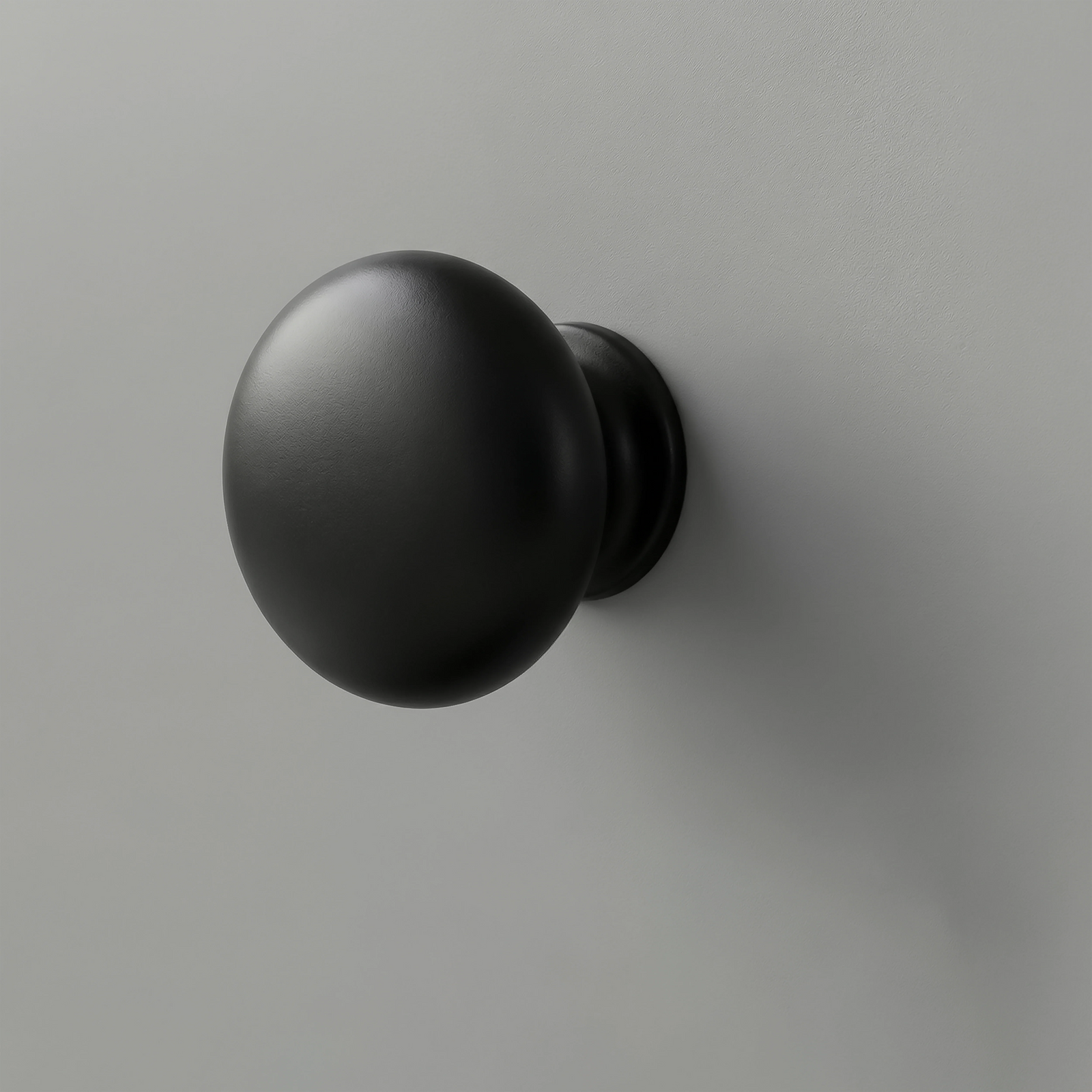 [Grey] Haven close-up of matte black round drawer knob set against light grey painted drawer front