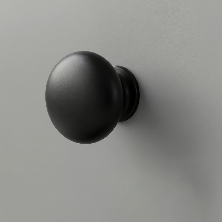 [Grey] Haven close-up of matte black round drawer knob set against light grey painted drawer front