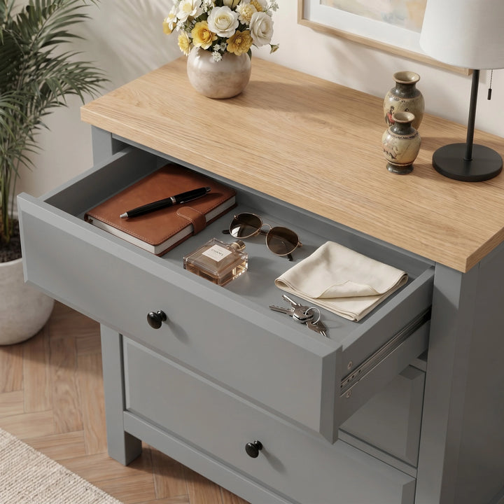 [Grey] Haven top drawer open showing notebook, sunglasses, perfume bottle, folded cloth, and keys