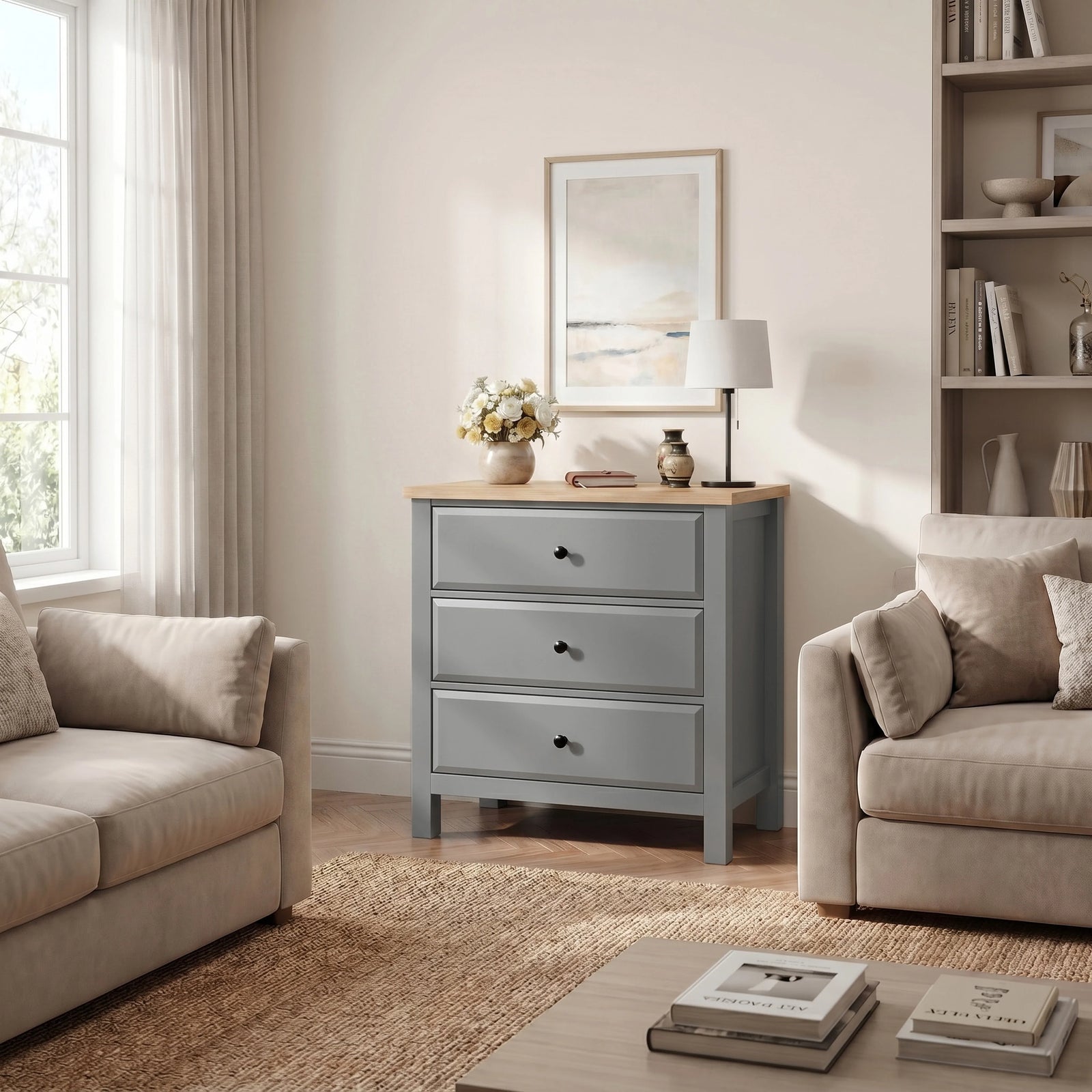 [Grey] Haven lifestyle room view with three drawers, oak-effect top, sofas, window, wall art, and shelving