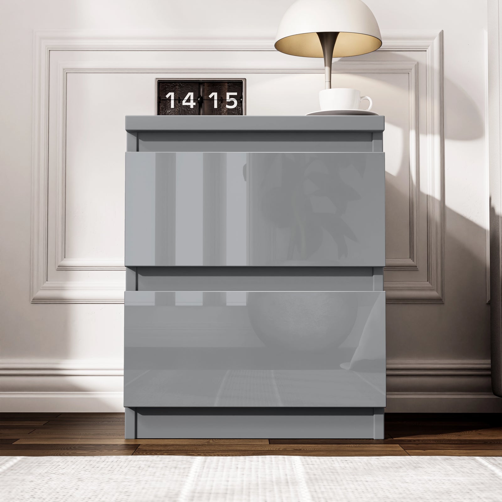[Grey] front view of grey 2 drawer bedside from the high gloss bedroom range, lamp lit beside flip clock