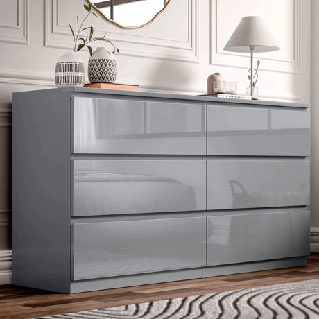 [Grey] High gloss 6 drawer chest styled in bedroom with mirror lamp and decorative accents.