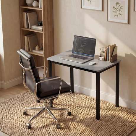 [80 X 50 cm] Home Office Desk in a sunlit study corner with leather chair, laptop showing code, magazine holder, bookshelf, and framed botanical art
