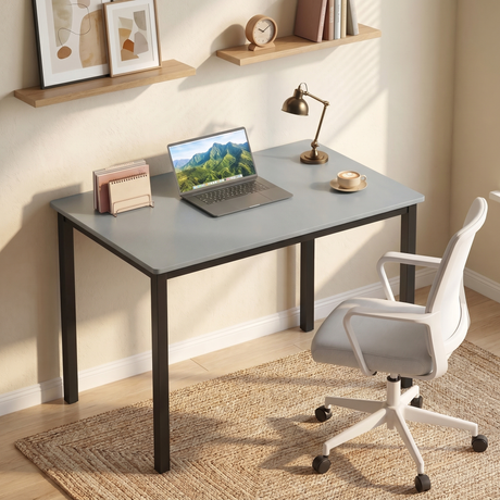 [80 X 50 cm] Home Office Desk styled in a beige room with laptop, brass lamp, coffee cup, white swivel chair, and floating shelf with framed art
