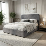 Angled room view of grey velvet king ottoman storage bed highlighting padded headboard and frame design