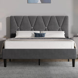 Gray upholstered bed with tufted headboard in a bedroom setting