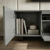 [Grey] Kystra TV stand close-up of left cabinet, internal shelf with books, chrome hinges, rear cable hole