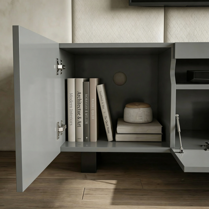 [Grey] Kystra TV stand close-up of left cabinet, internal shelf with books, chrome hinges, rear cable hole