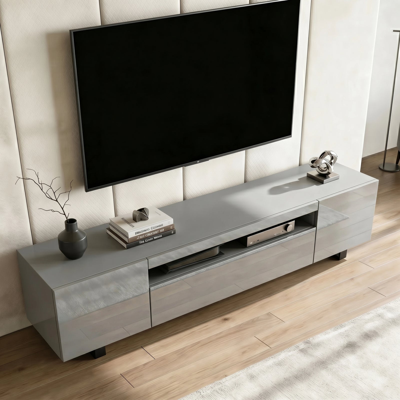 [Grey] Kystra TV stand seen from above on plank flooring, gloss top finish and slim black legs visible
