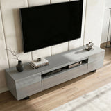[Grey] Kystra TV stand seen from above on plank flooring, gloss top finish and slim black legs visible