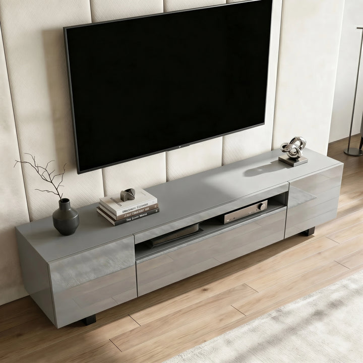 [Grey] Kystra TV stand seen from above on plank flooring, gloss top finish and slim black legs visible