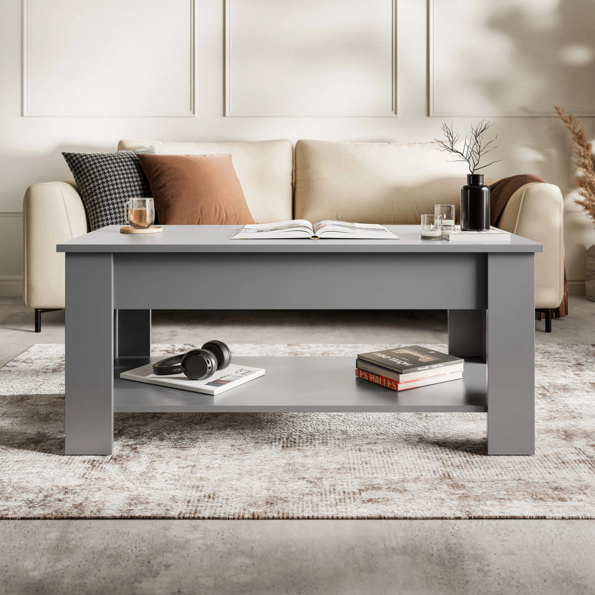 [Grey] Lift top coffee table closed front view in grey with book and drinks on top.