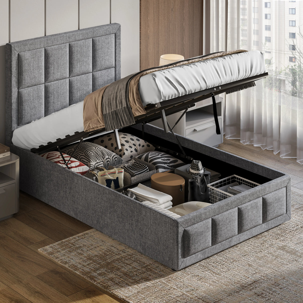 Light grey single ottoman storage bed with gas lift mechanism open, revealing spacious underbed storage for linens and accessories.