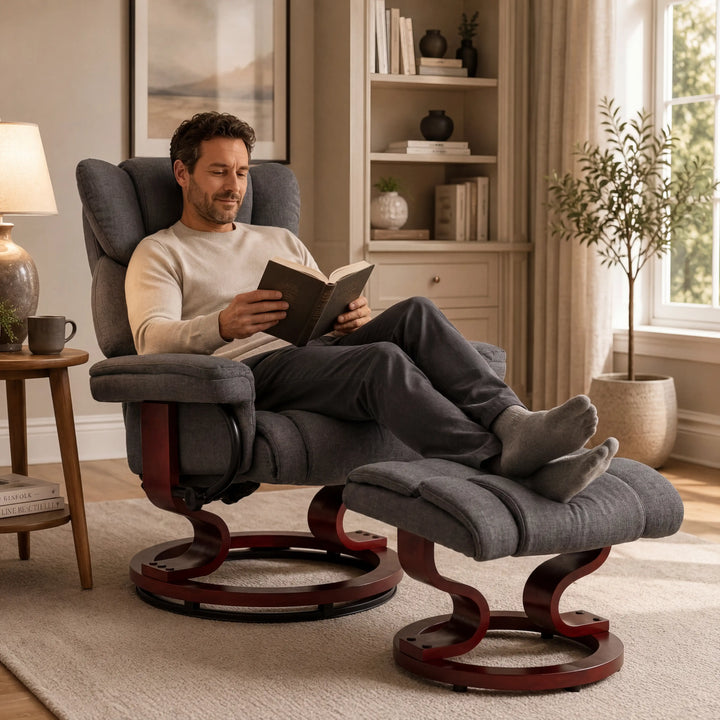 [Grey - Linen] man relaxes on upholstered recliner chair with an attached matching ottoman, reading a book in a bright, neutral-toned living room