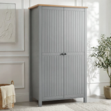 [Grey] Linra 2 Door Wardrobe in a bright white panelled room with woven basket and large olive tree to the right, angle view